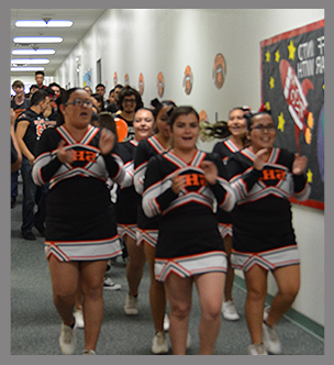 Group of happy cheerleaders in the hallway