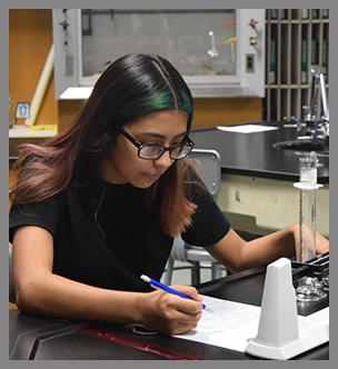 Two students work on a project in a lab