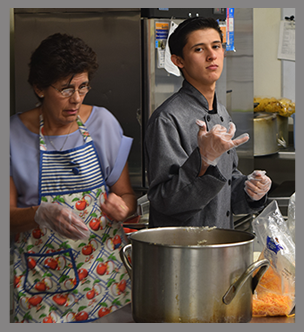 Student and teacher work in a kitchen