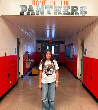Female student smiling in the school hallway
